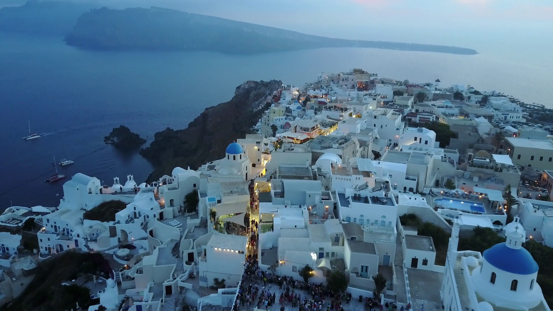 Aerial Footage Of A Cliffside Village At Sunset In Santorini