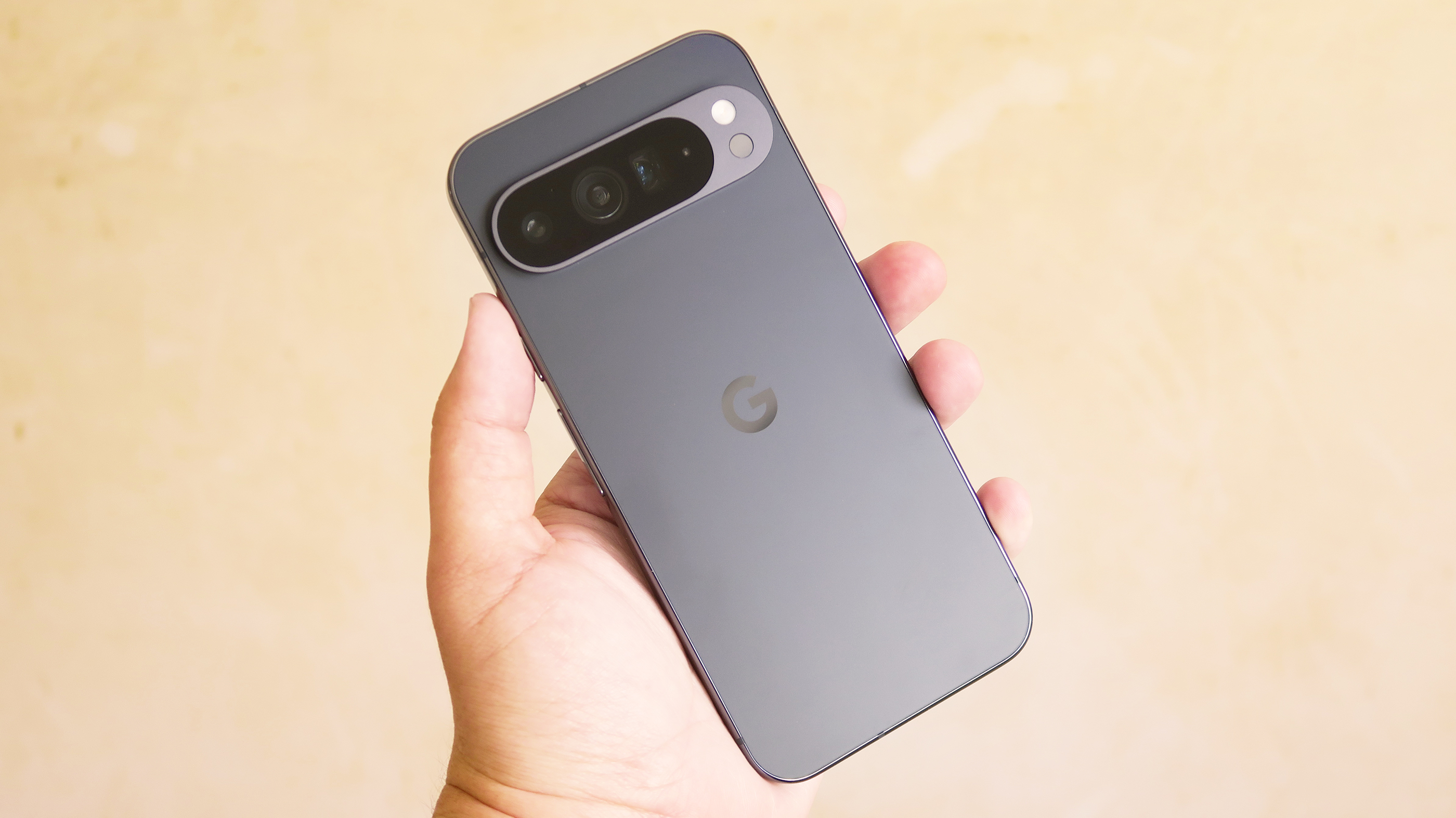 A Google Pixel 7 phone held in a hand, showcasing its sleek design and rear camera array