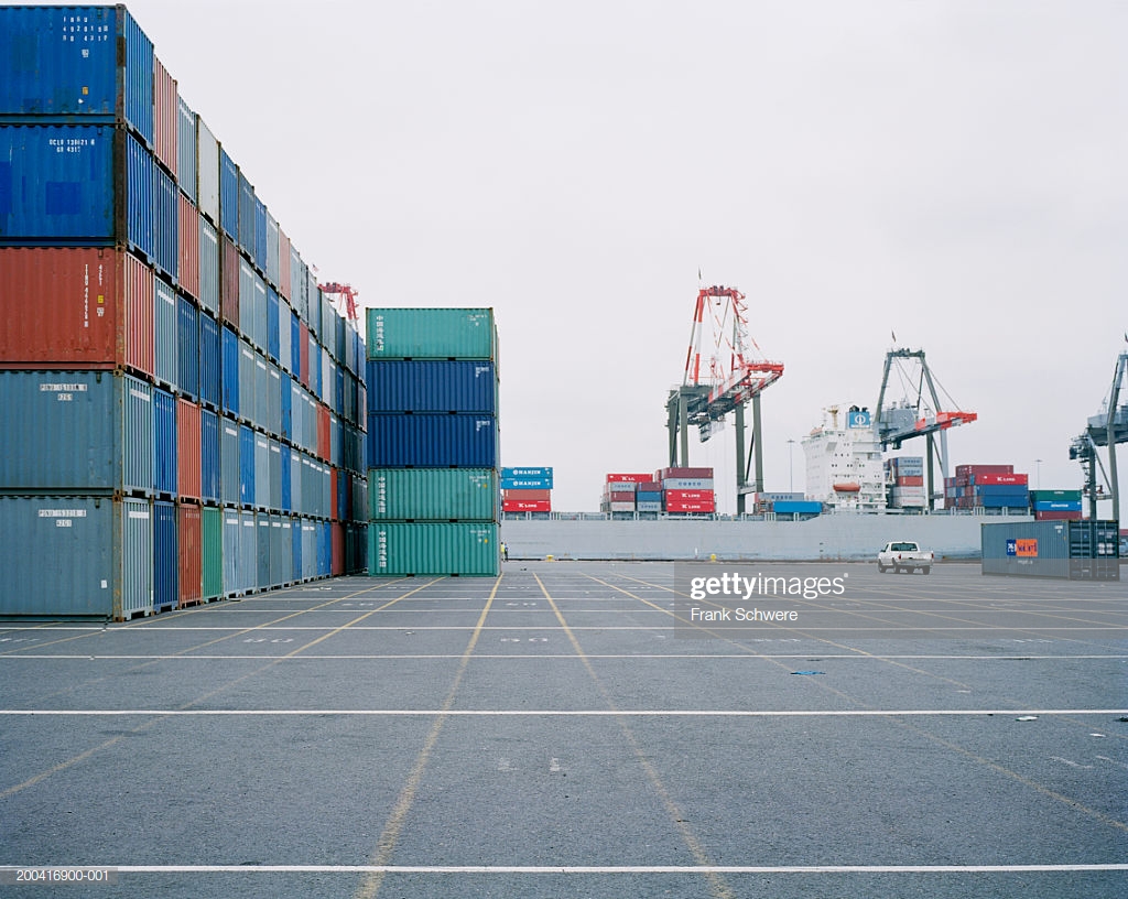 Stacked Shipping Containers In Port Hydraulic Cranes Background