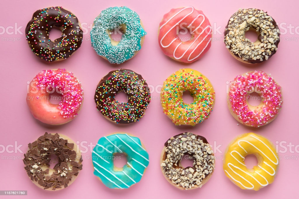 Colorful Sweet Background Delicious Glazed Donuts On Pink
