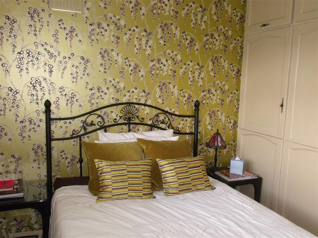 Photo Of Bold Gold Yellow Bedroom With Feature Wall Pattern Wallpaper