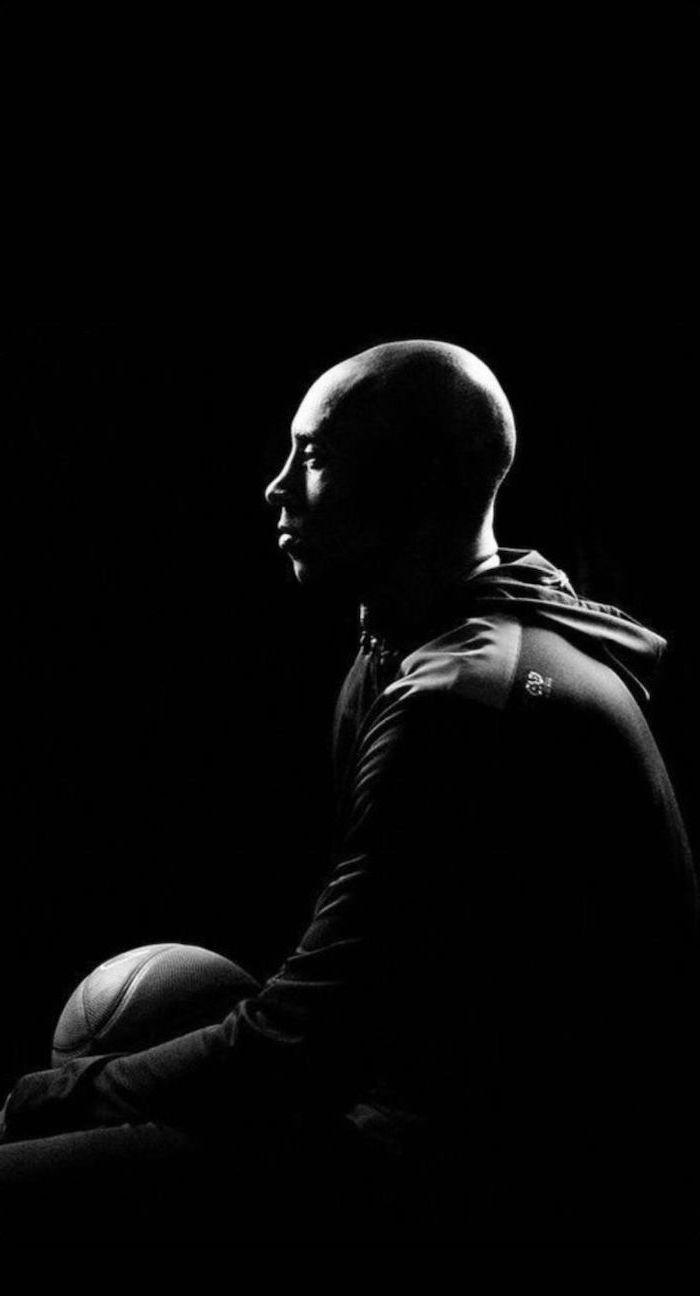 Black And White Photo Of Kobe Sitting Holding A Basketball