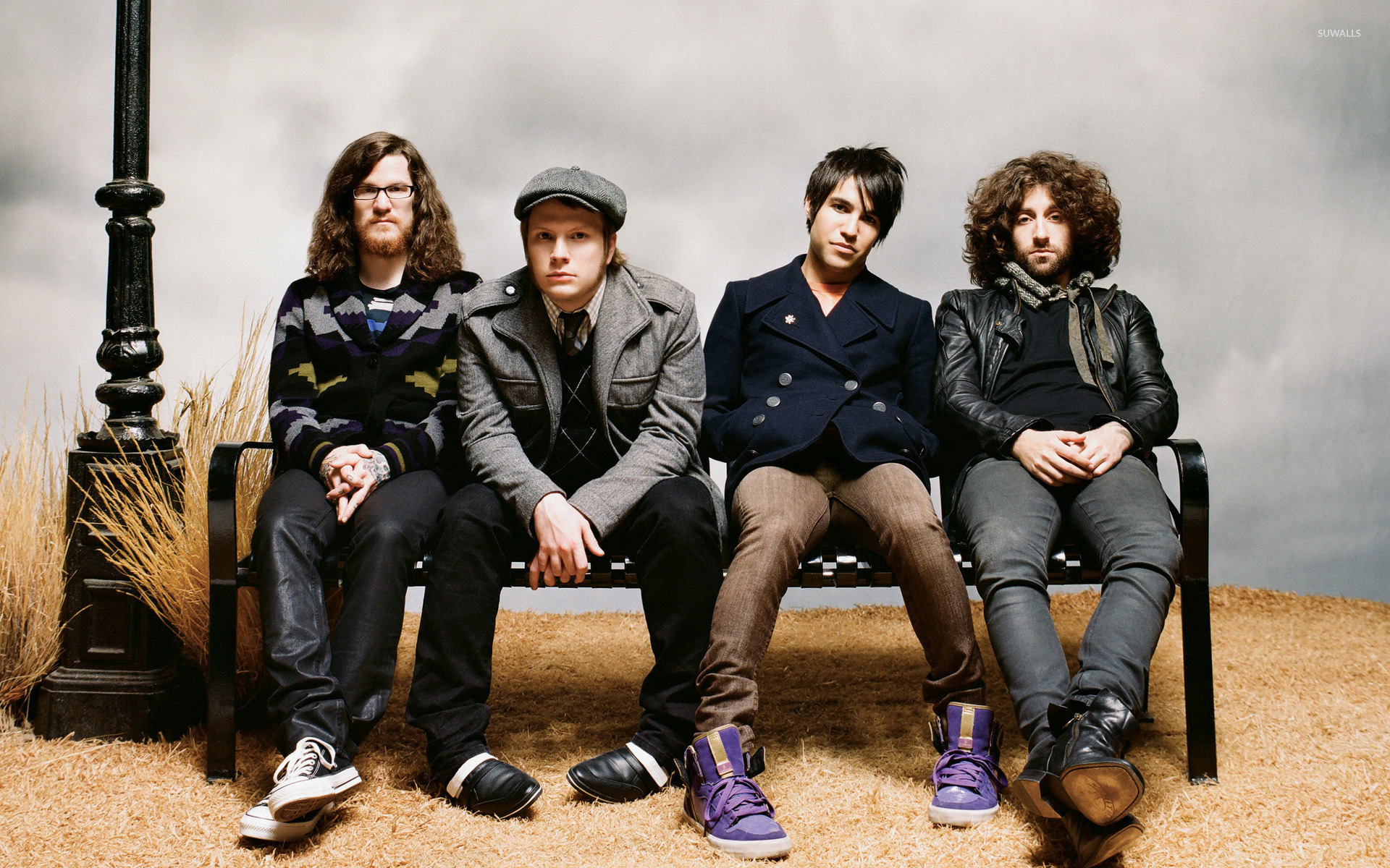 Fall Out Boy band members sitting on a bench
