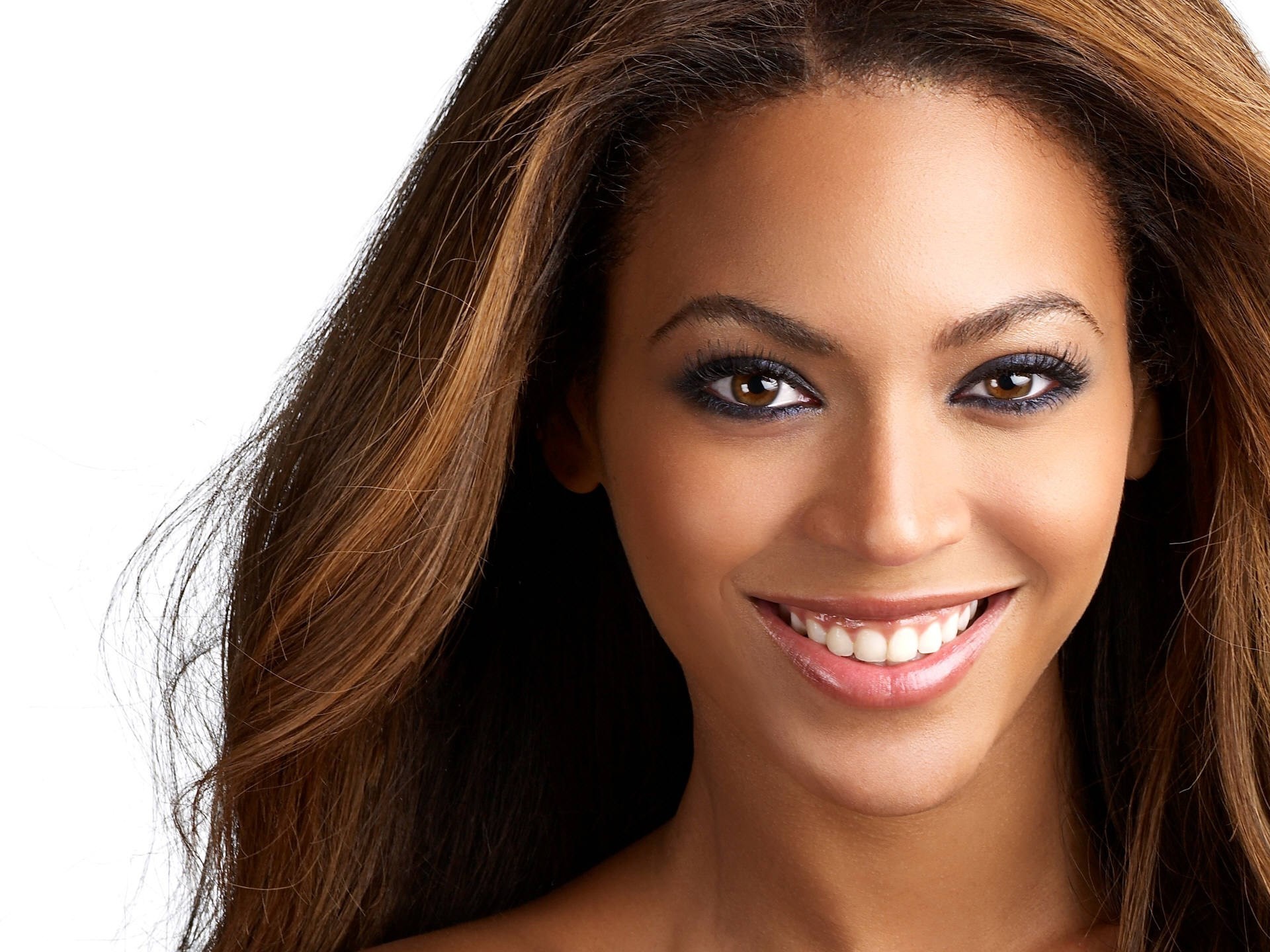 Close-up portrait of Beyoncé, showcasing her radiant smile and captivating gaze