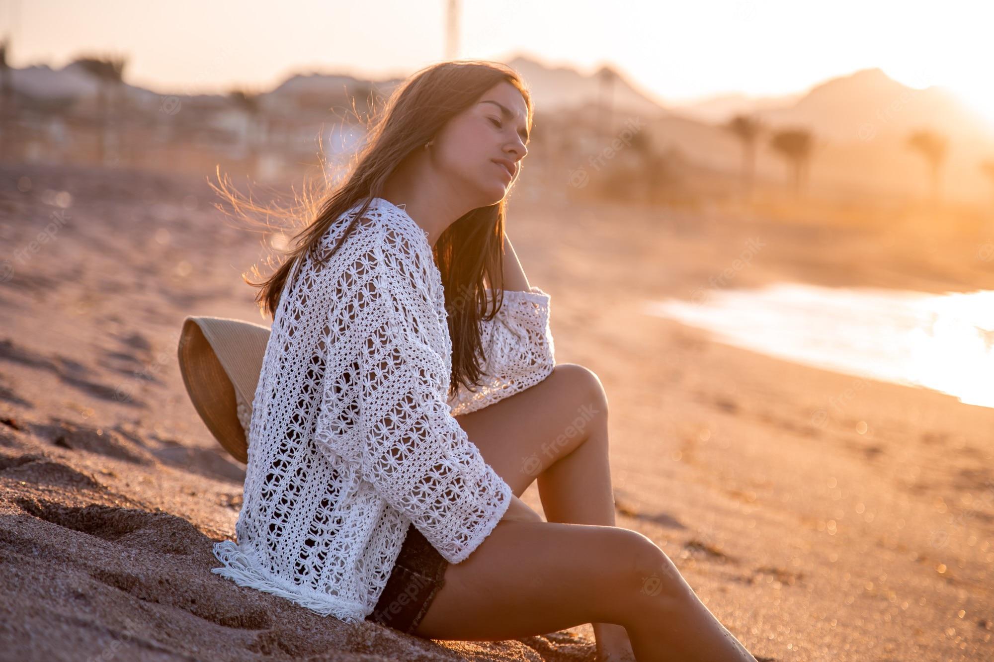 Premium Photo Beautiful Young Woman In A Boho Style Cape Sits On