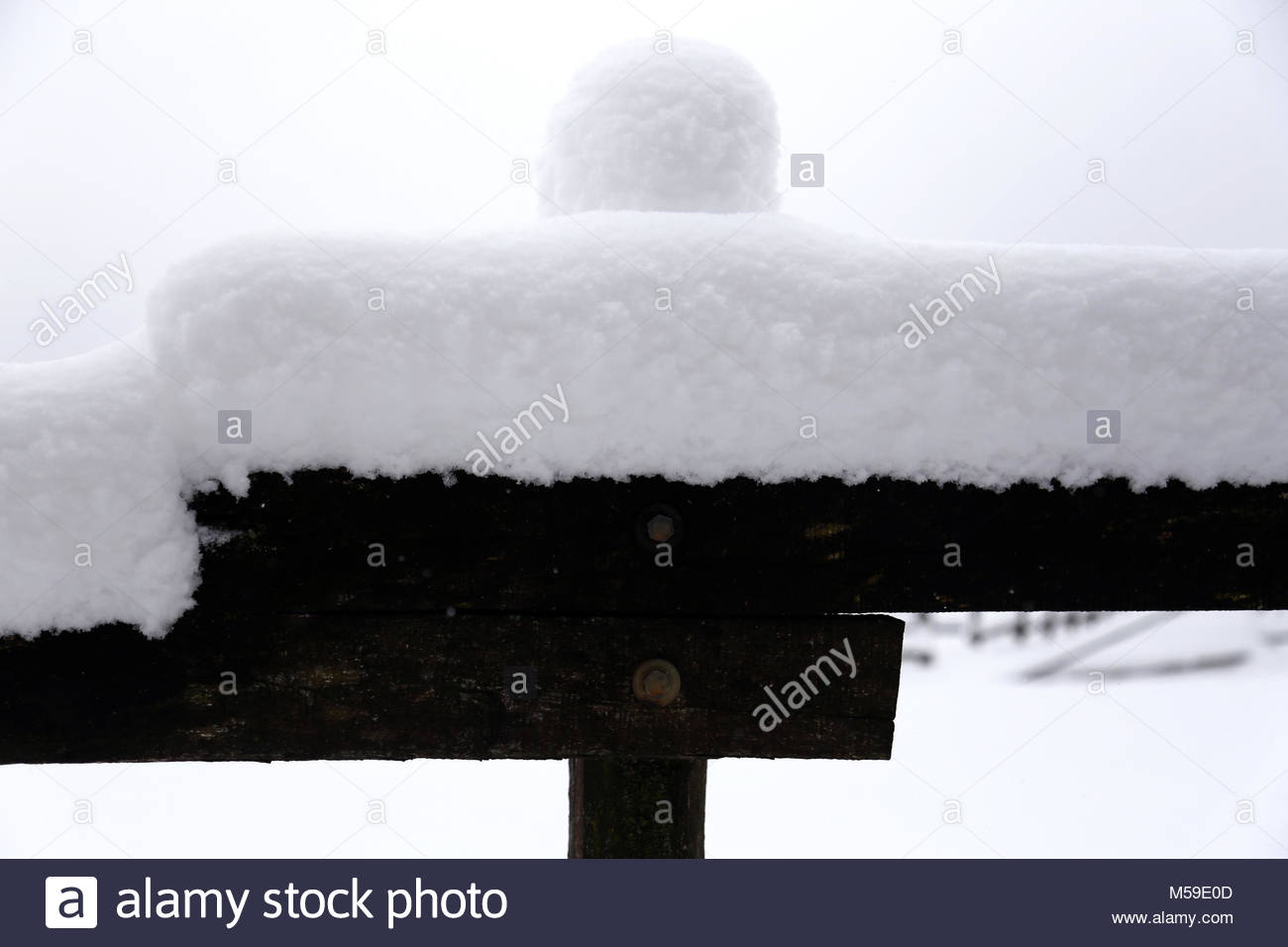Closeup Of Snowy Corral Poles As A Winter Background Stock Photo