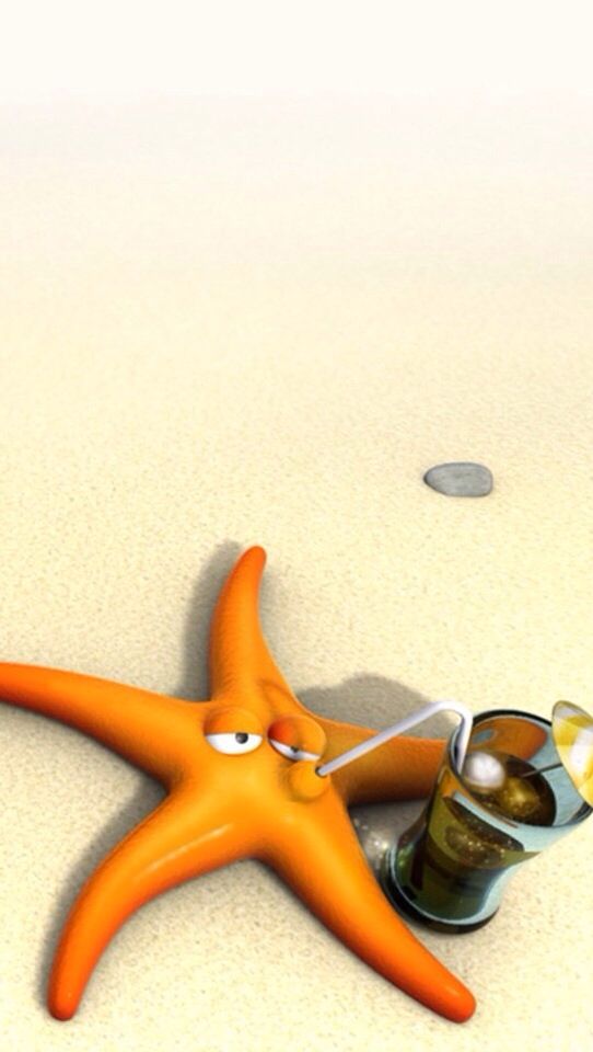 Starfish Lying In The Sand With A Straw Drinking From Glass
