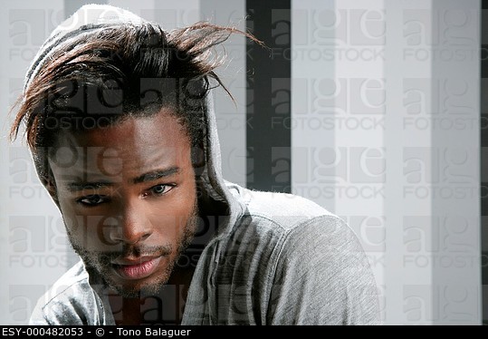 African American Man With Gray Hood Over Wallpaper Background Esy
