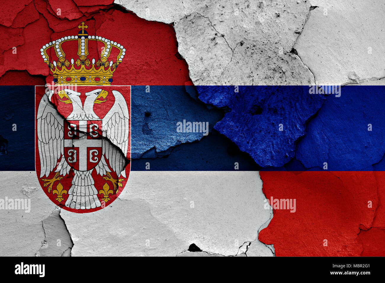 Flags Of Serbia And Russia Painted On Cracked Wall Stock Photo