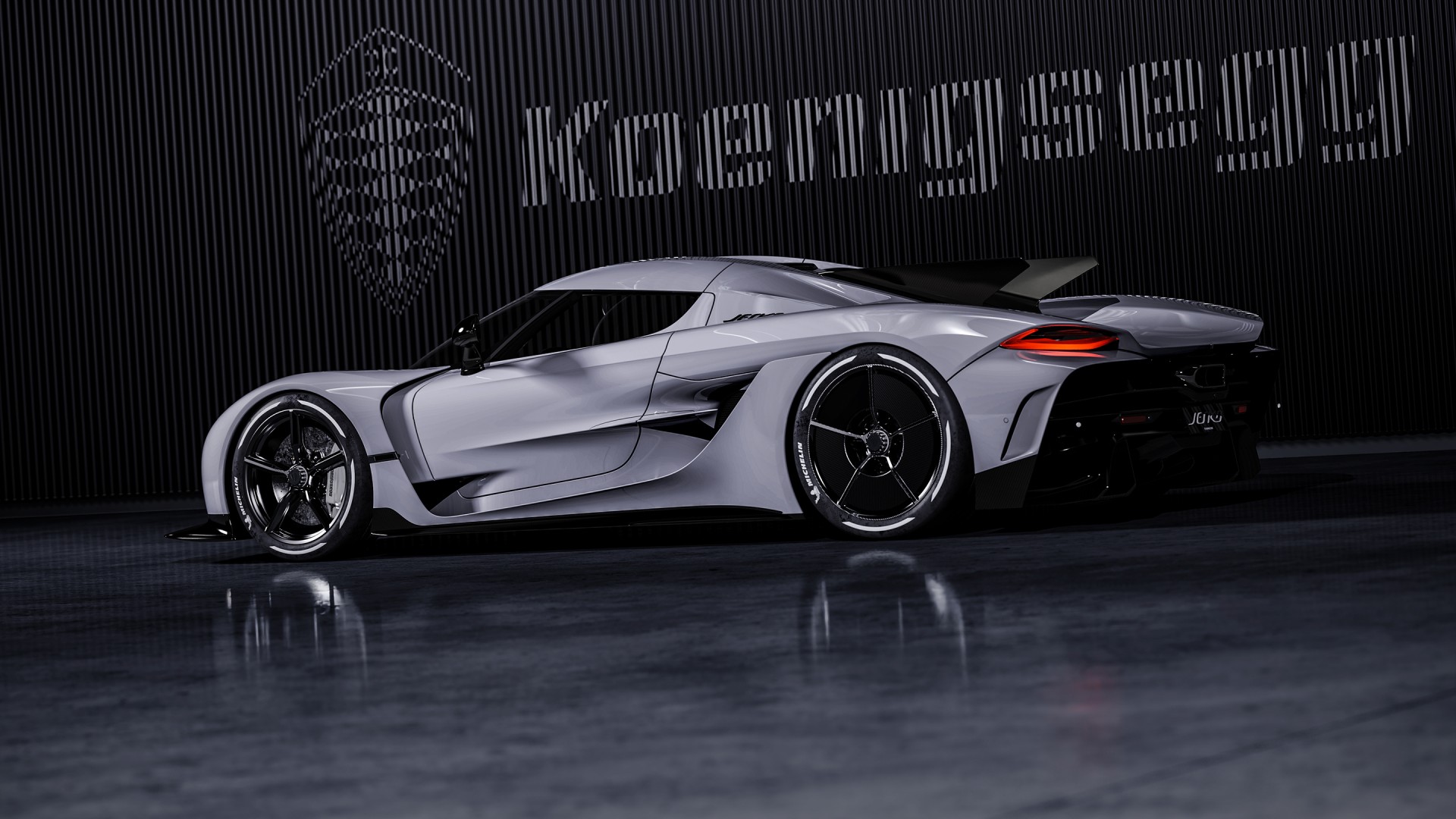 A sleek, silver Koenigsegg sports car parked in a dark garage, illuminated by ambient light, reflecting on the polished floor