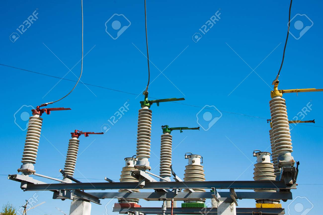 High Voltage Power Transformer Substation On Blue Sky Background