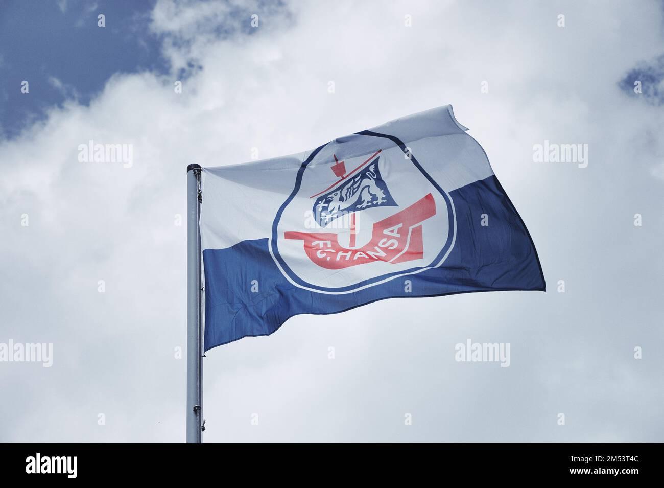 The FC Hansa Rostock flag blowing in the wind with a cloudy sky in
