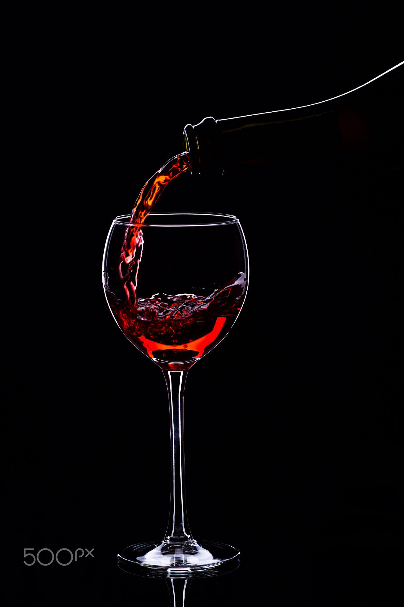 Red Wine In Glasses And Bottle On A Black Background