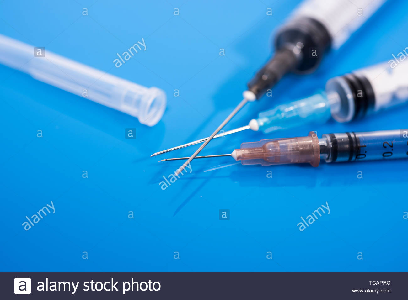 Vaccination Time Vaccine In Vial With Syringe On Clock Background