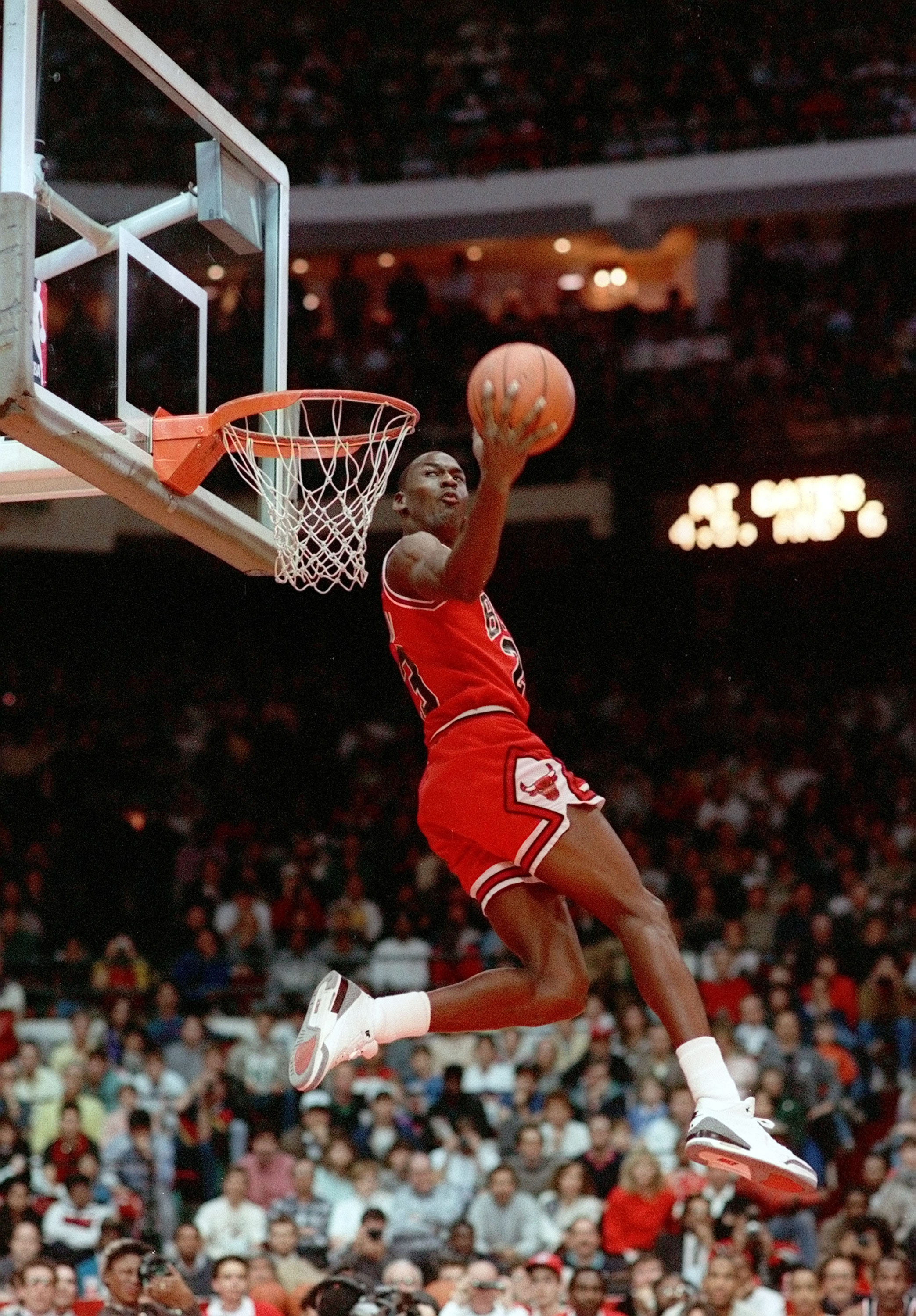 Michael Jordan performing a breathtaking slam dunk in a Chicago Bulls game