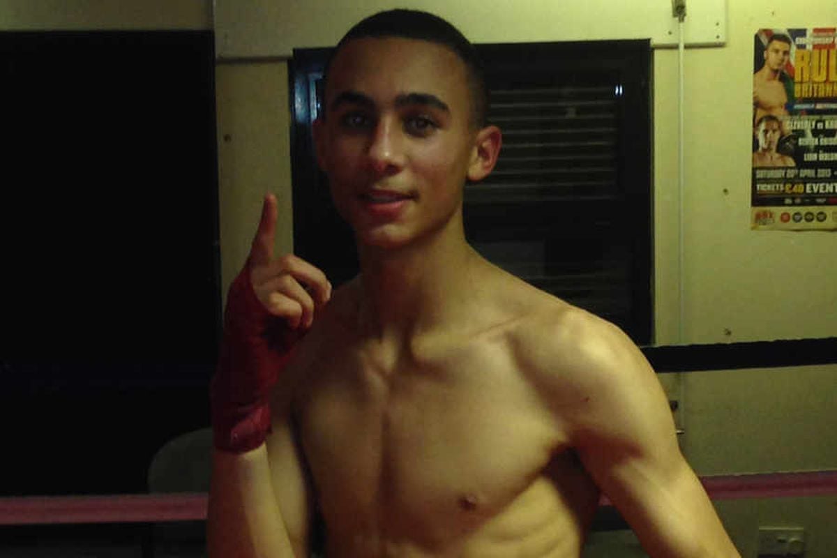 Benjamin Whittaker posing for a photo after a boxing match, with his hand raised and a focused expression