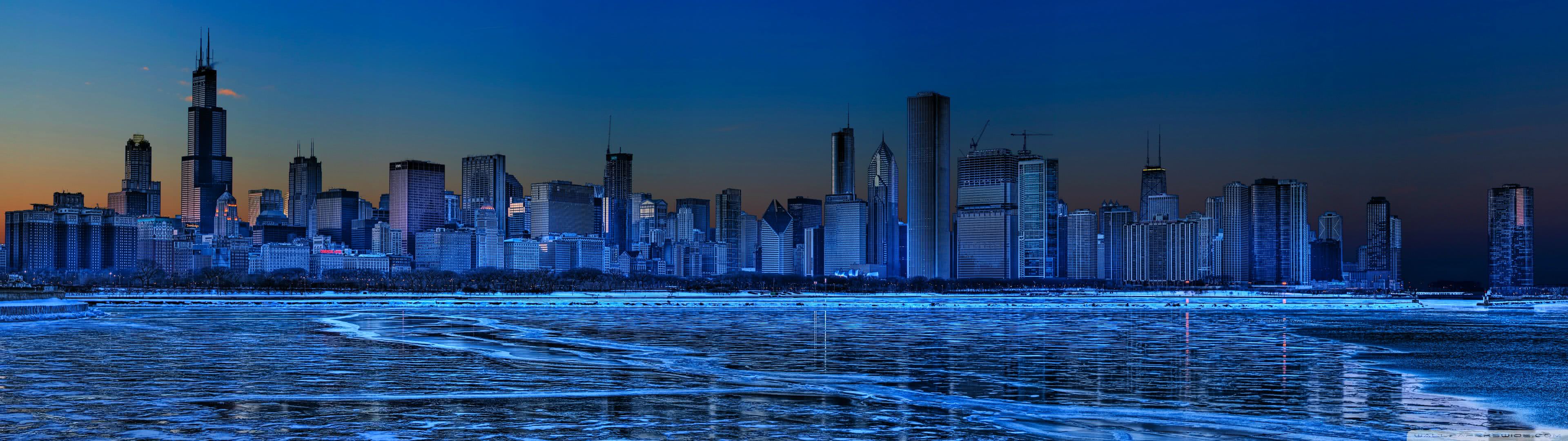Stunning panoramic view of the Chicago skyline at dusk, with the icy waters of Lake Michigan in the foreground