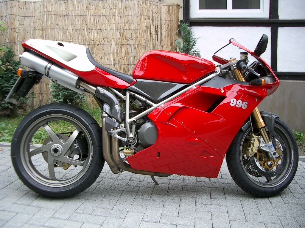 Red and White Ducati 996 Motorcycle Parked on Brick Driveway