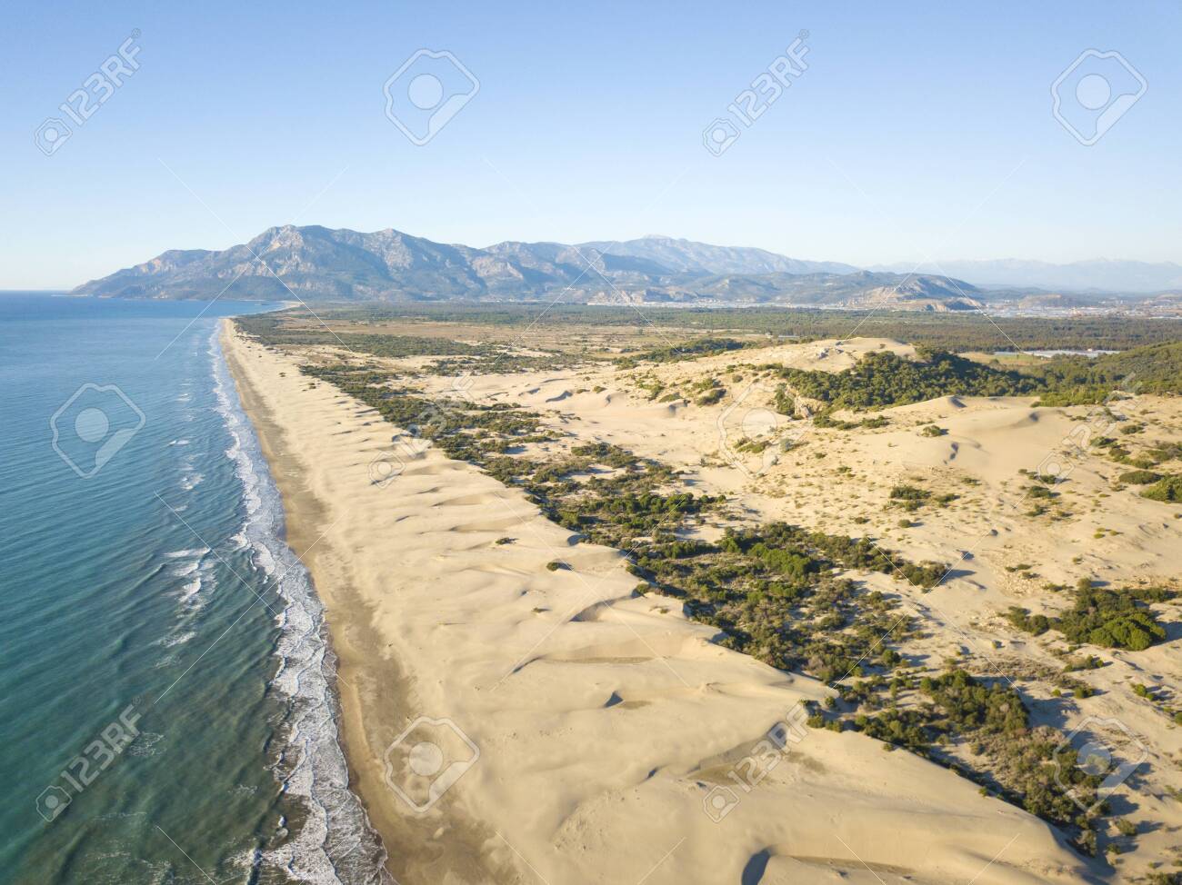 Aerial Drone Of Sand Dunes And Sea Coast With Mountain
