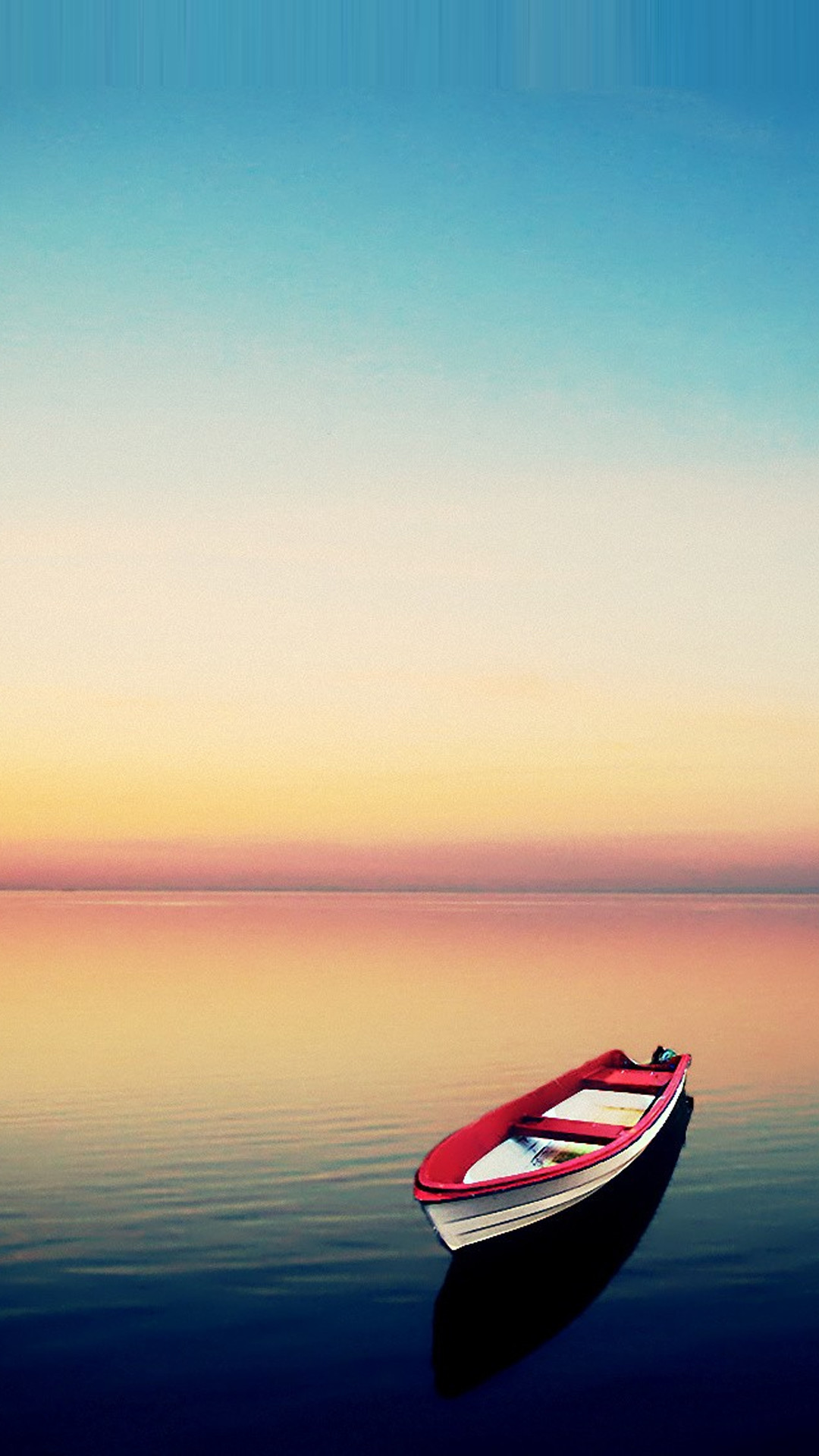 A serene sunset over calm water with a small red and white boat. Perfect wallpaper for mobile phones