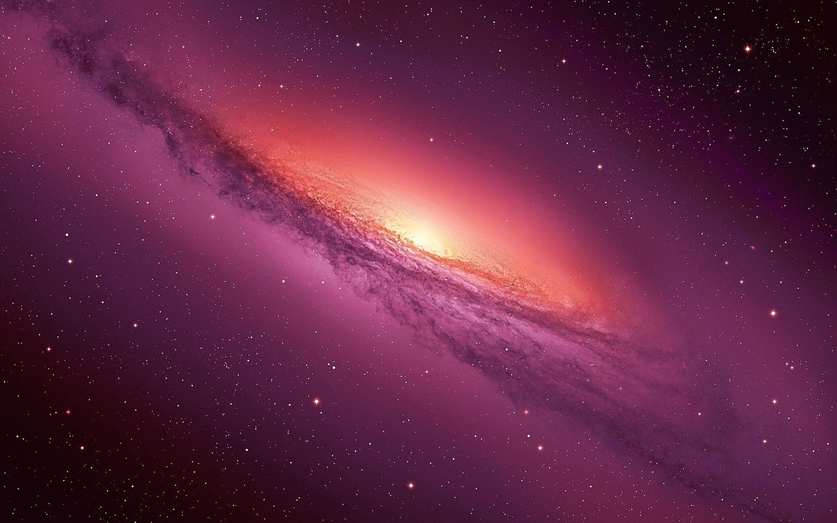 A breathtaking view of a spiral galaxy with a vibrant pink and purple hue, perfect for a desktop wallpaper