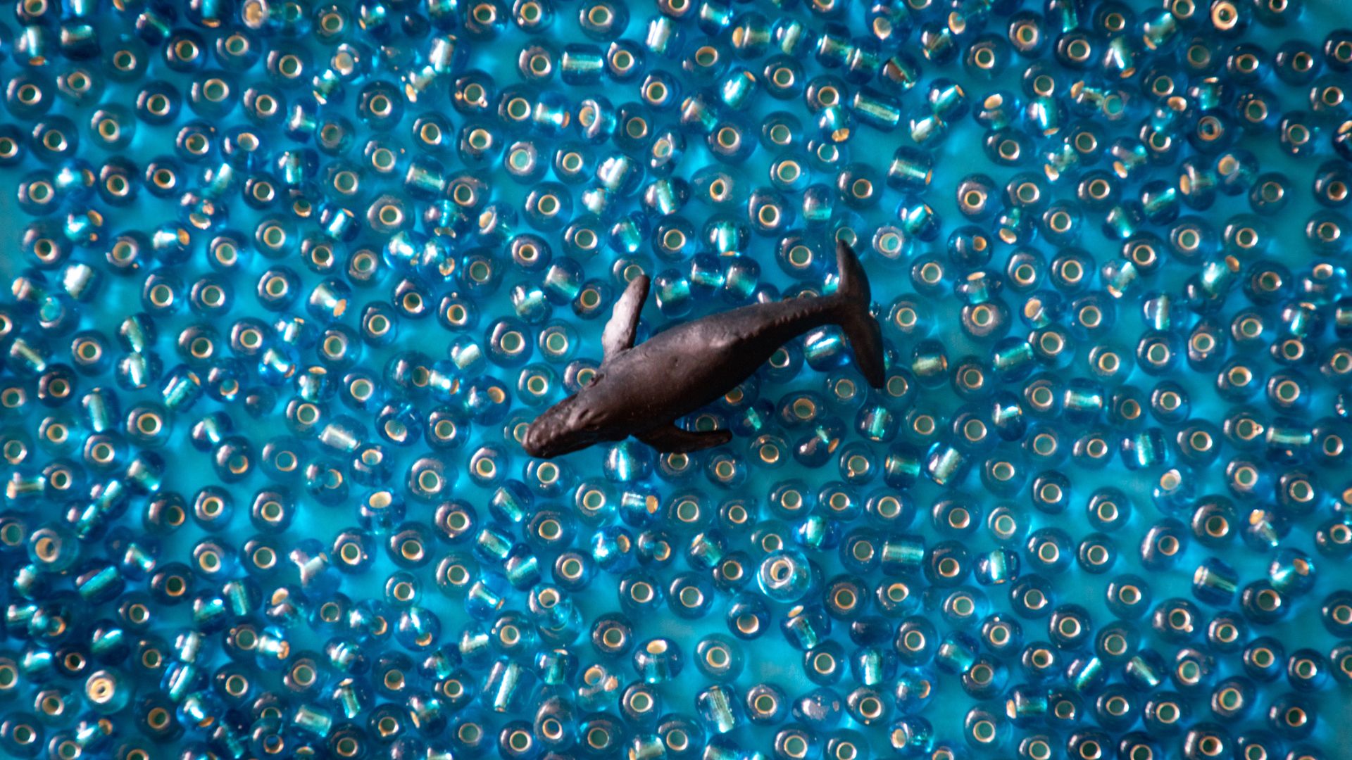 Black Fish Toy On Blue Pearls Wallpaper Stream