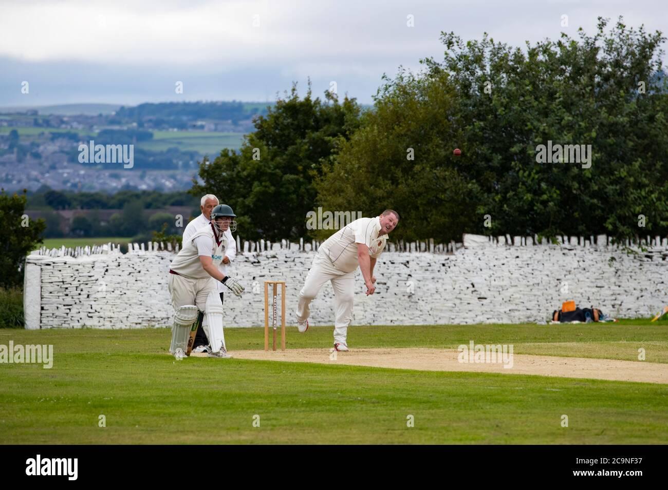 Medium paced bowler in a village cricket match bowling a delivery