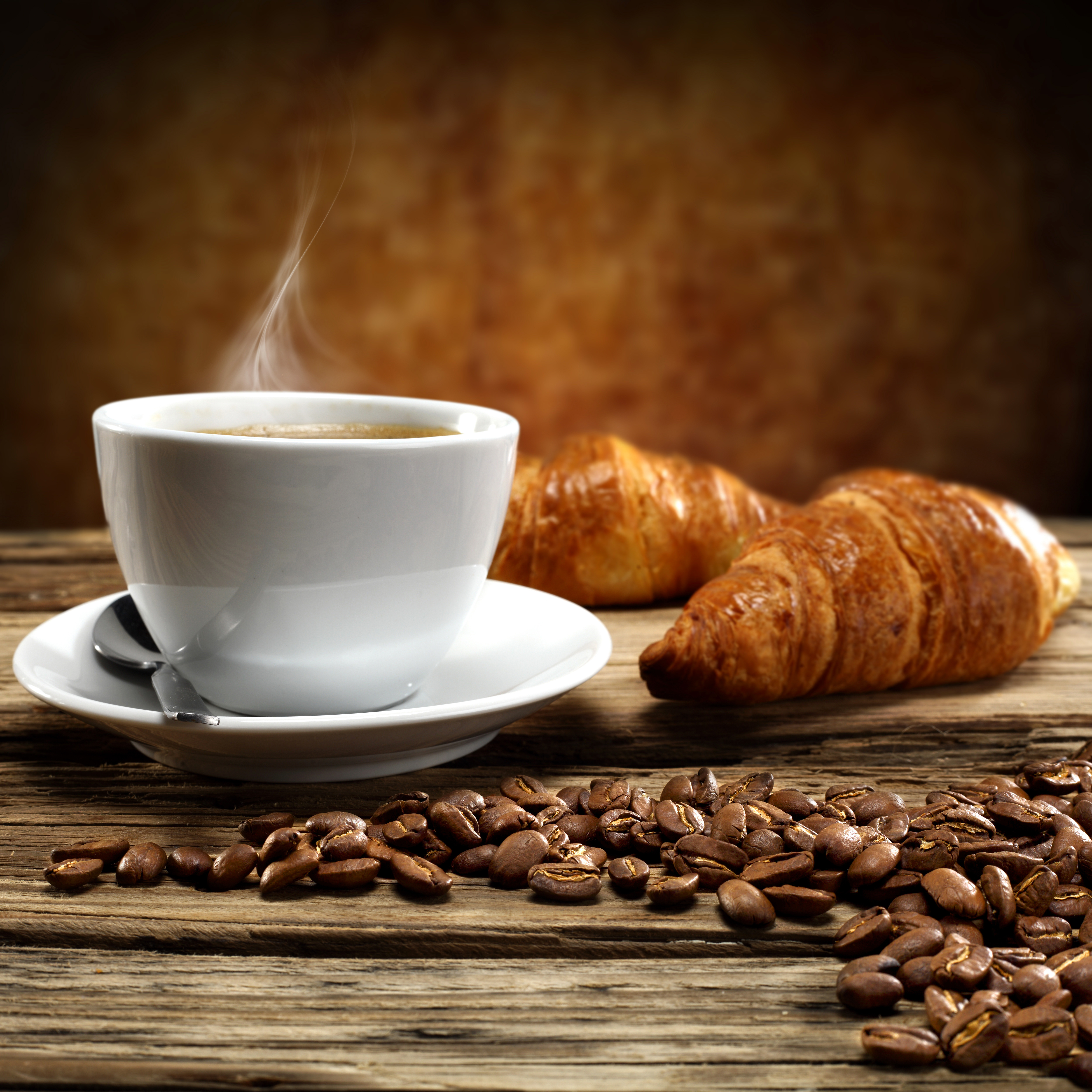 Cup Of Coffee Seeds And Croissants Background