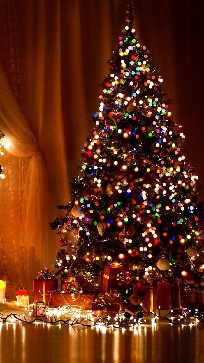 decorated christmas tree with lots of colorful lights merry
