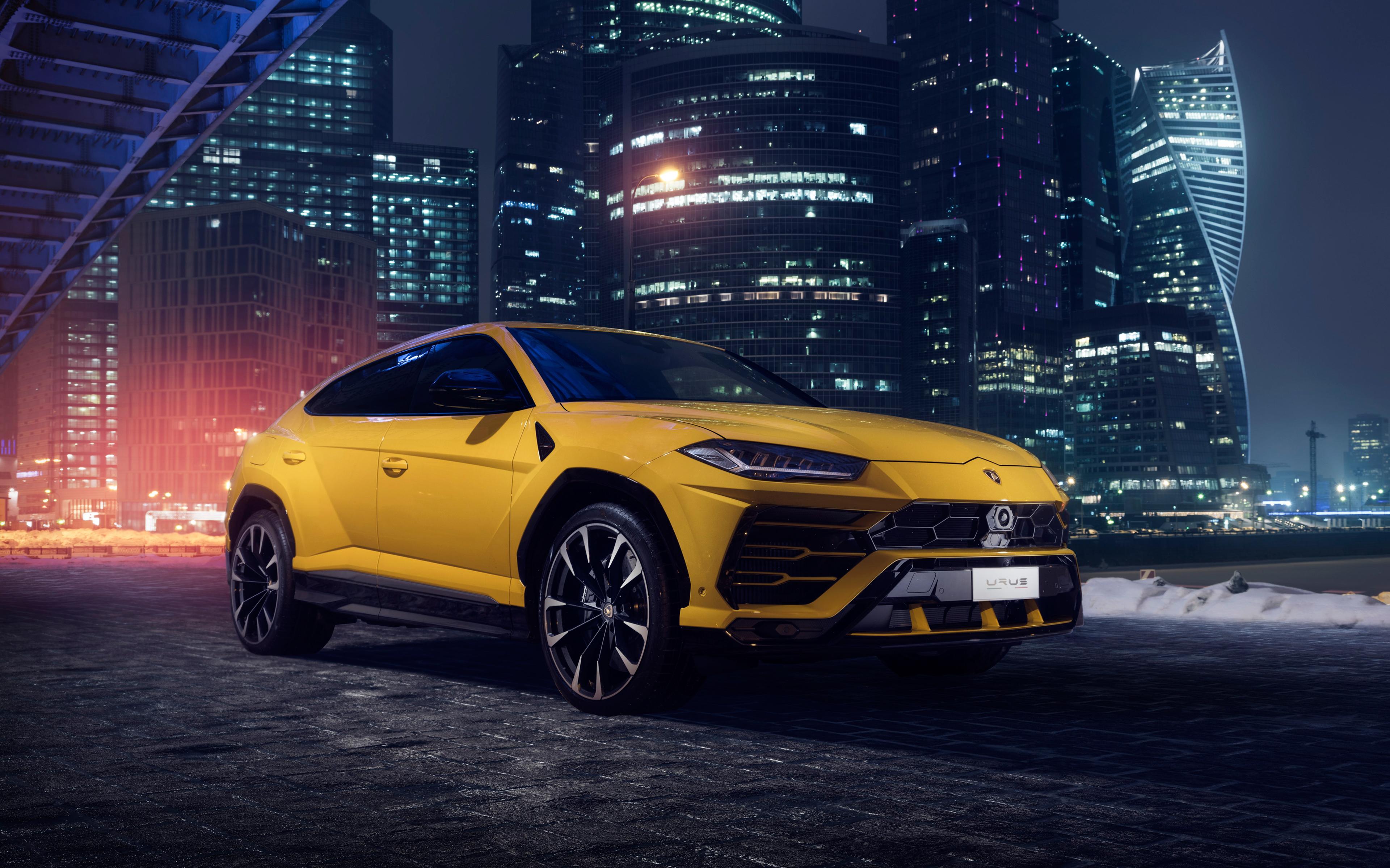 Yellow Lamborghini Urus Against The Background Of Night