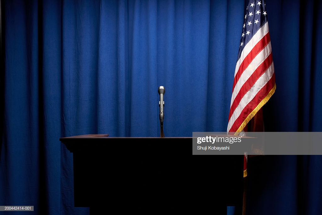 Podium With Microphone Us Flag In Background High Res Stock Photo