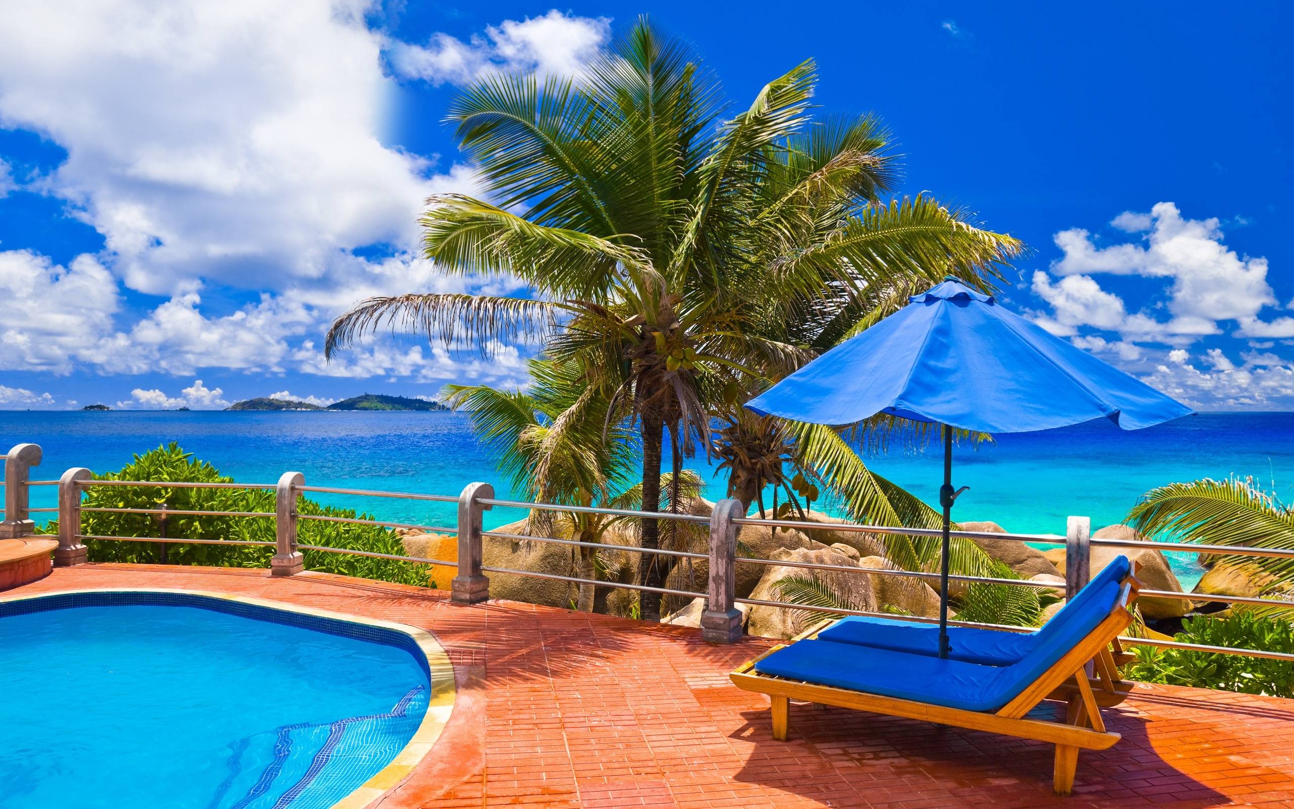 Luxury summer vacation scene with pool, lounge chairs, and ocean view