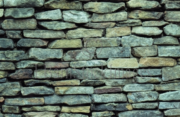 Stacked Stone Wall Consisting Of Rough Rectangular Blocks On