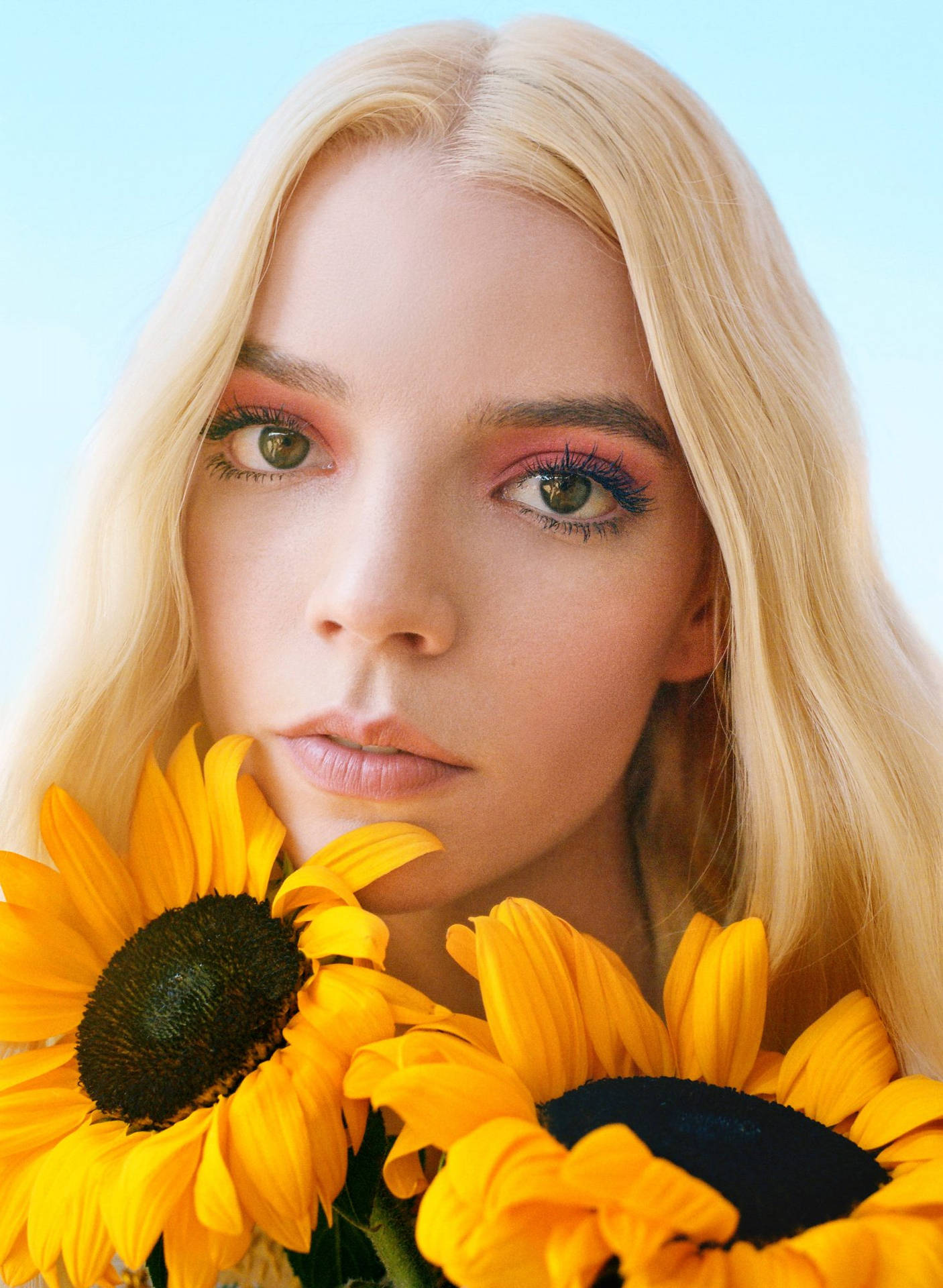 Close-up of Anya Taylor-Joy with sunflowers