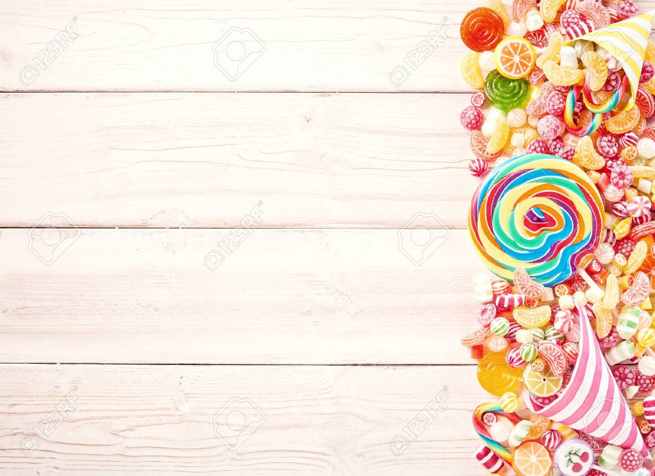 Background Of Wood Slat Table Piled With Sweets To One Side With
