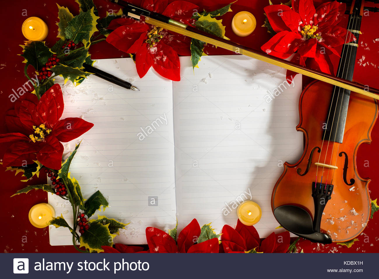 Violin and open music manuscript on the red background Christmas