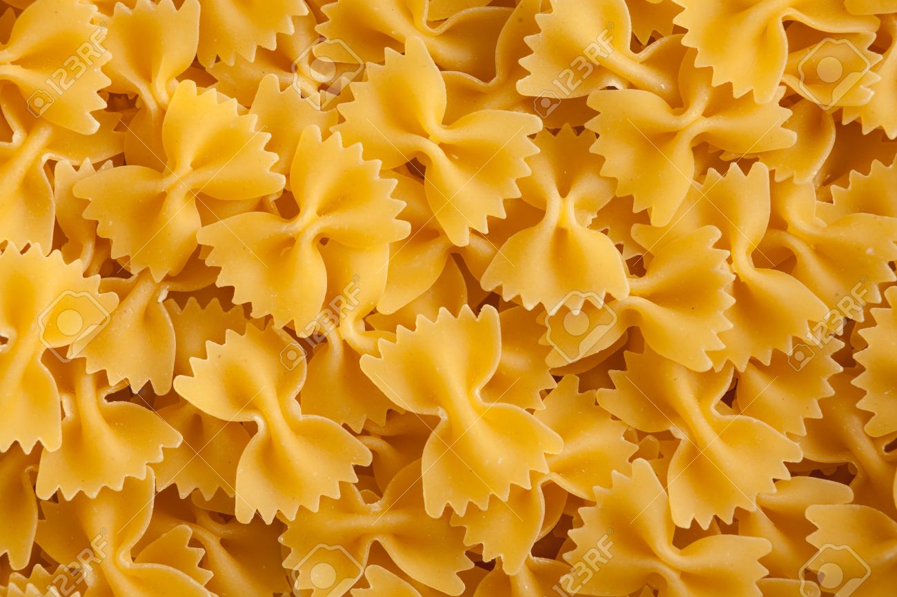 Some Farfalle Pasta Forming A Background Pattern Stock Photo