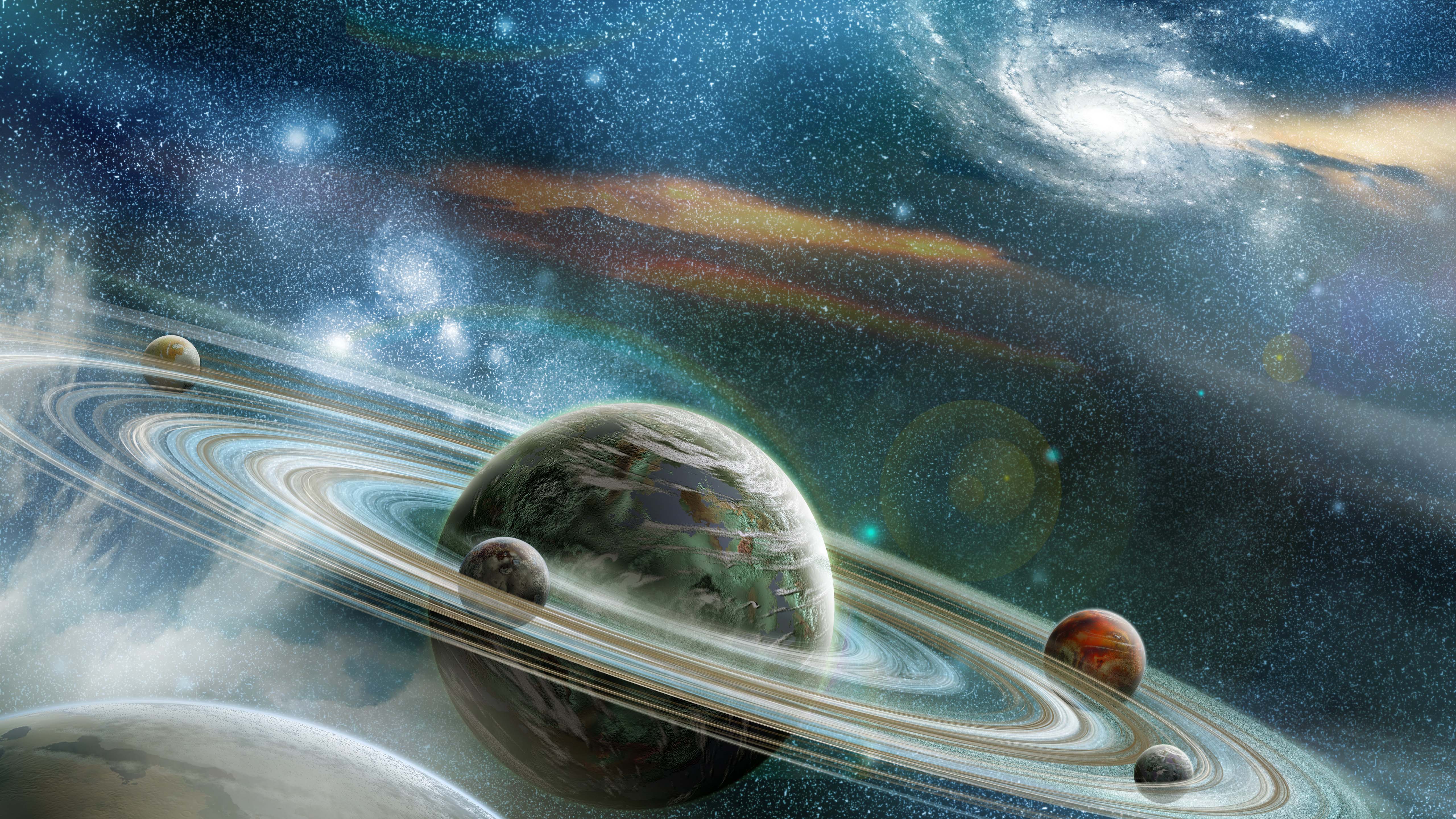 A stunning wallpaper featuring a green and gray ringed planet with multiple moons, set against a backdrop of a vibrant nebula and distant stars