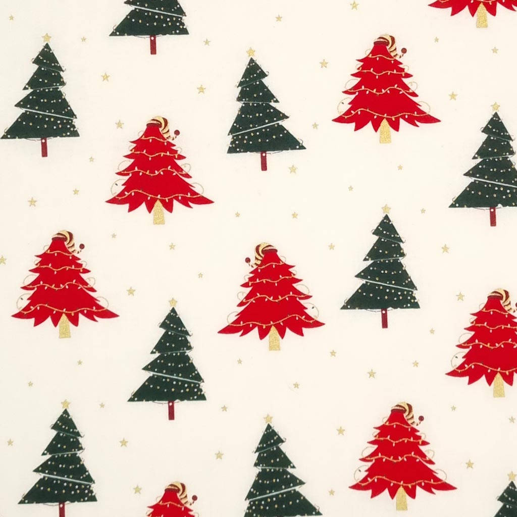 A preppy Christmas pattern with red and green Christmas trees and gold stars on a cream background