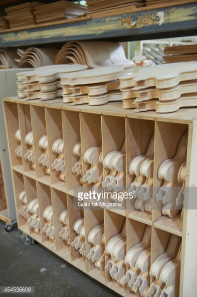 Shelves of unfinished guitar bodies at the Gibson guitar factory in 395x594