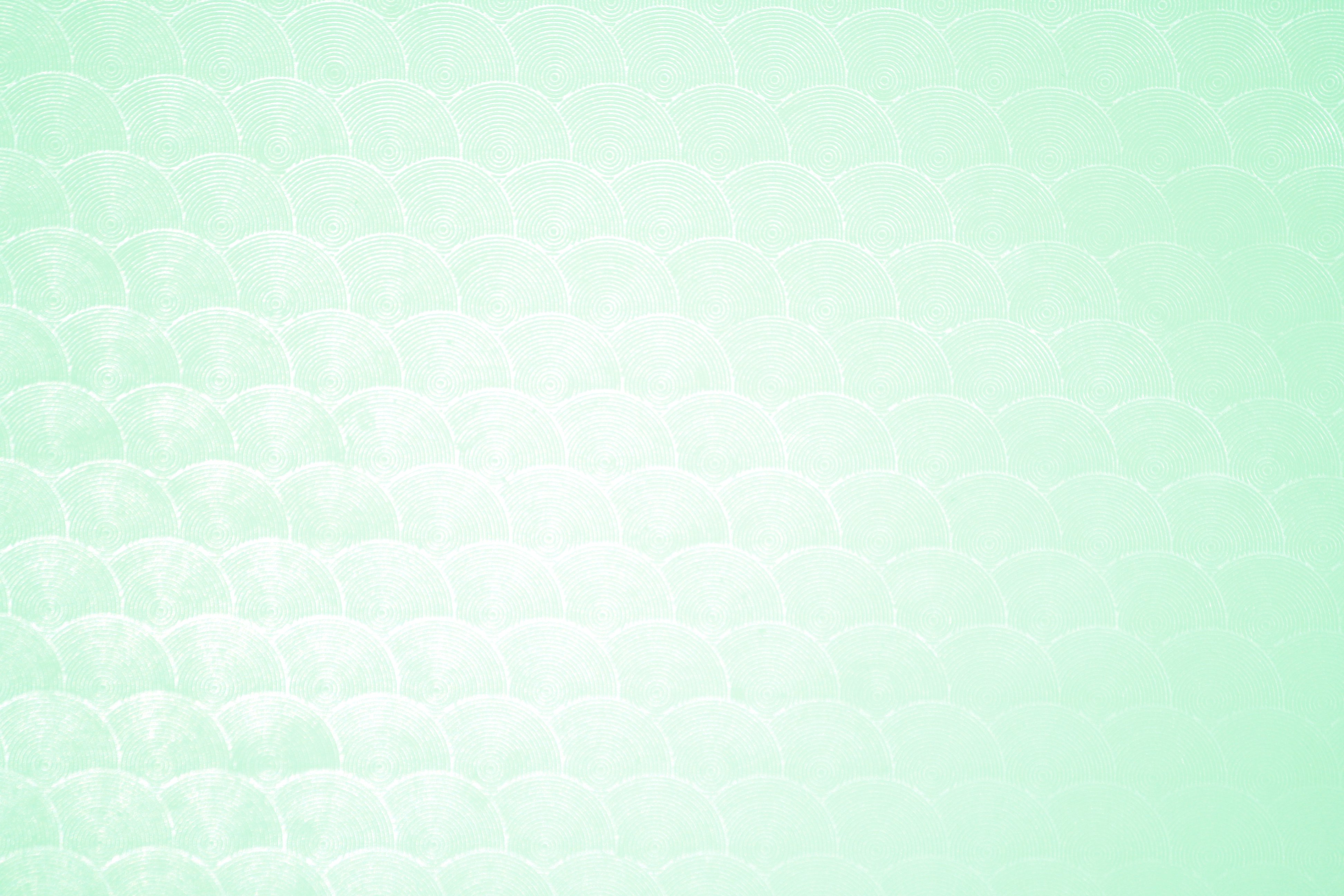 A mint green background with a subtle pattern of overlapping arches, creating a calming and refreshing aesthetic