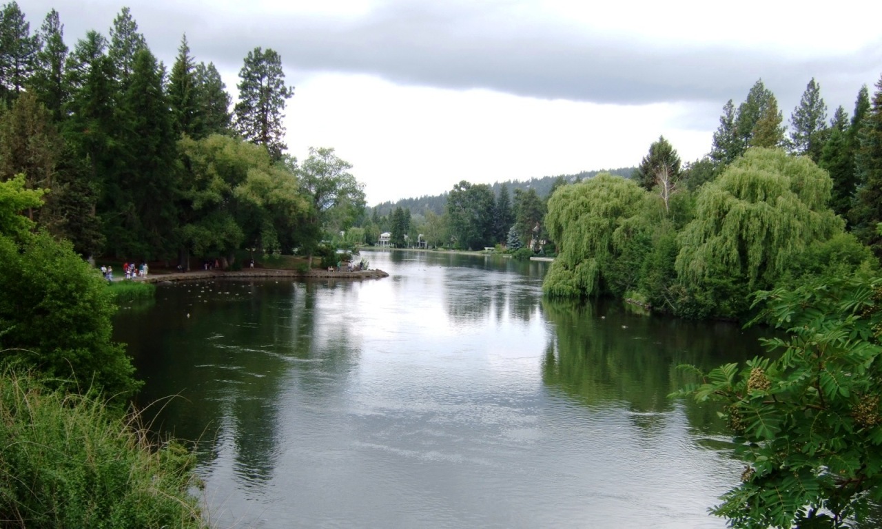 The Deschutes River Runs Along A Downtown Park In Bend