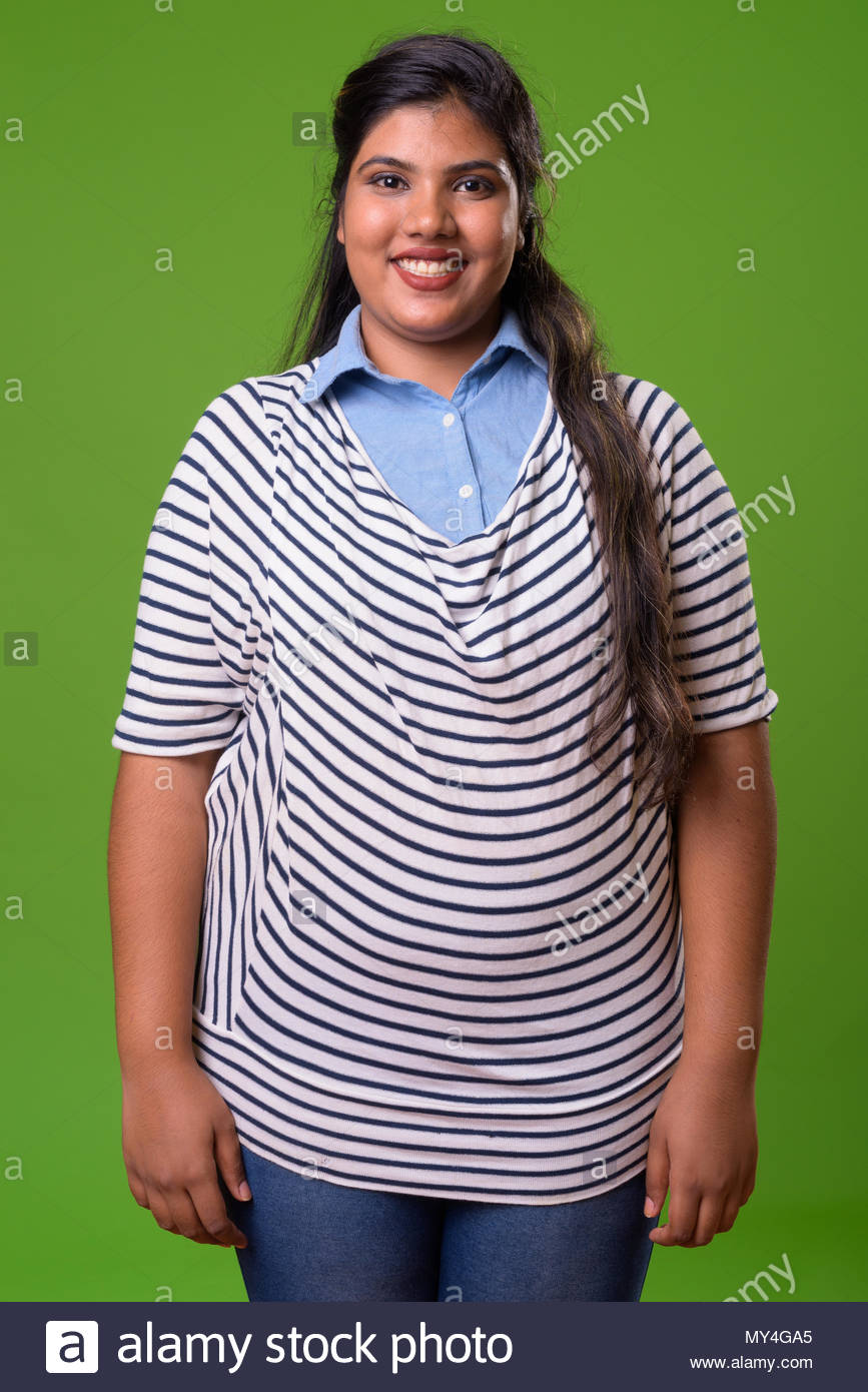 Young Overweight Beautiful Indian Businesswoman Against Green