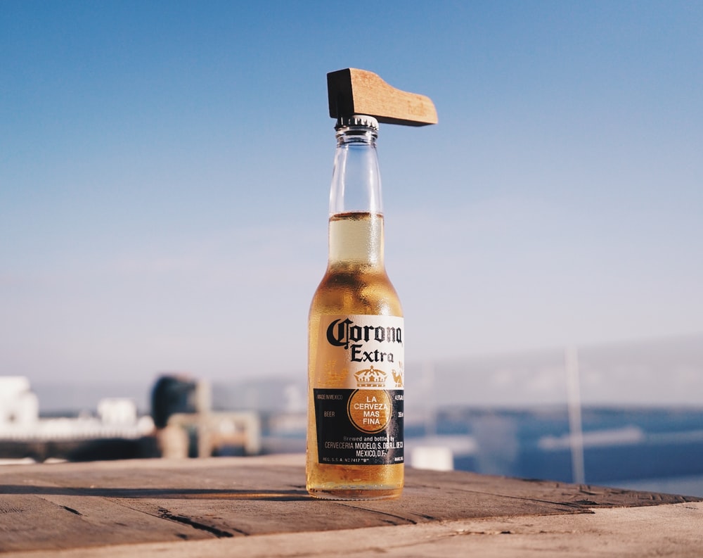 Corona Extra Beer Bottle On Brown Wooden Table Photo Image