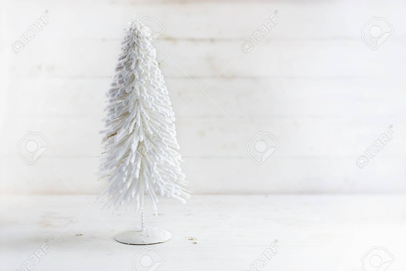White Artificial Christmas Tree From Flocked Wire On A Rustic
