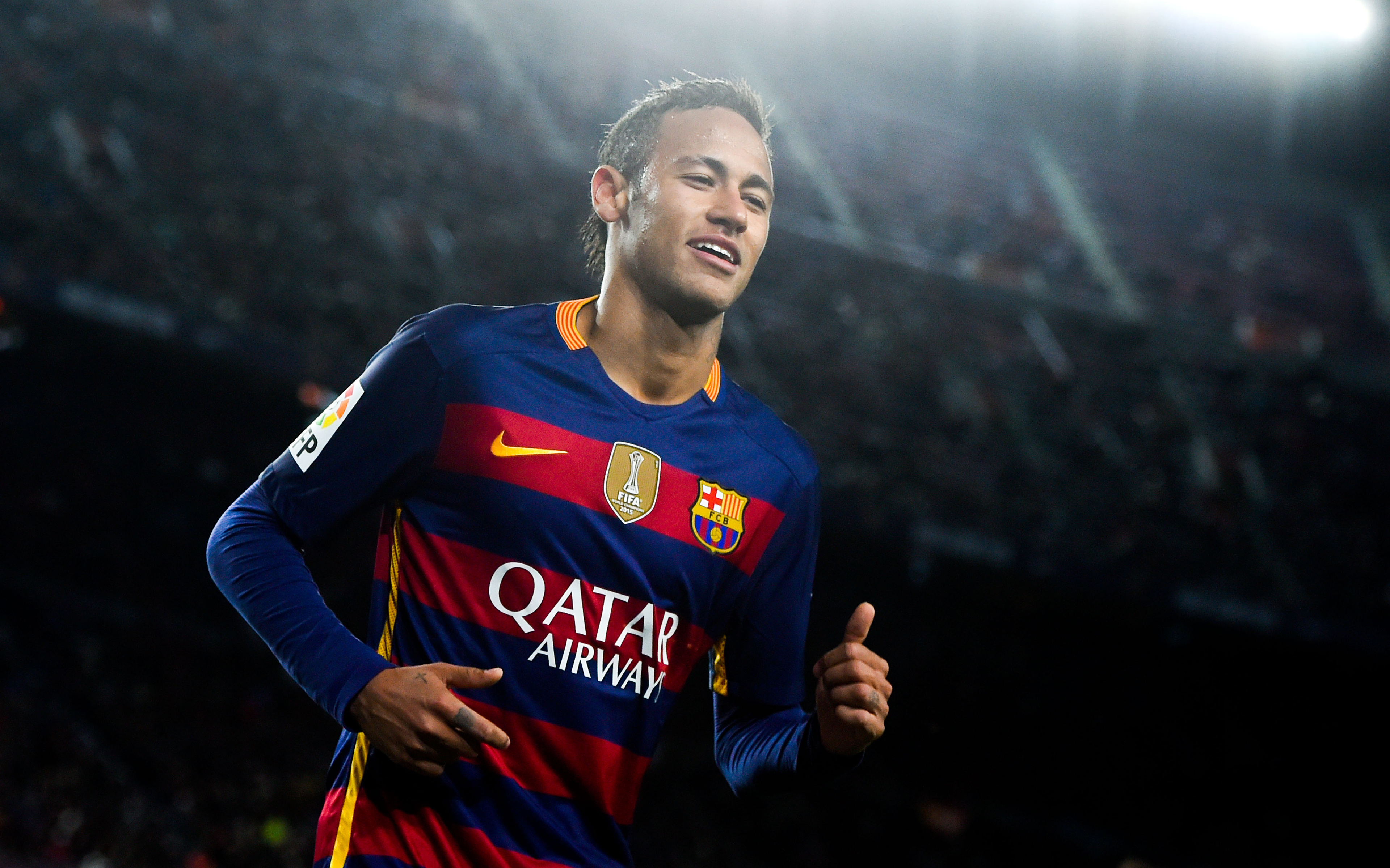 Neymar Jr. in a Barcelona jersey, smiling at the camera, during a soccer match