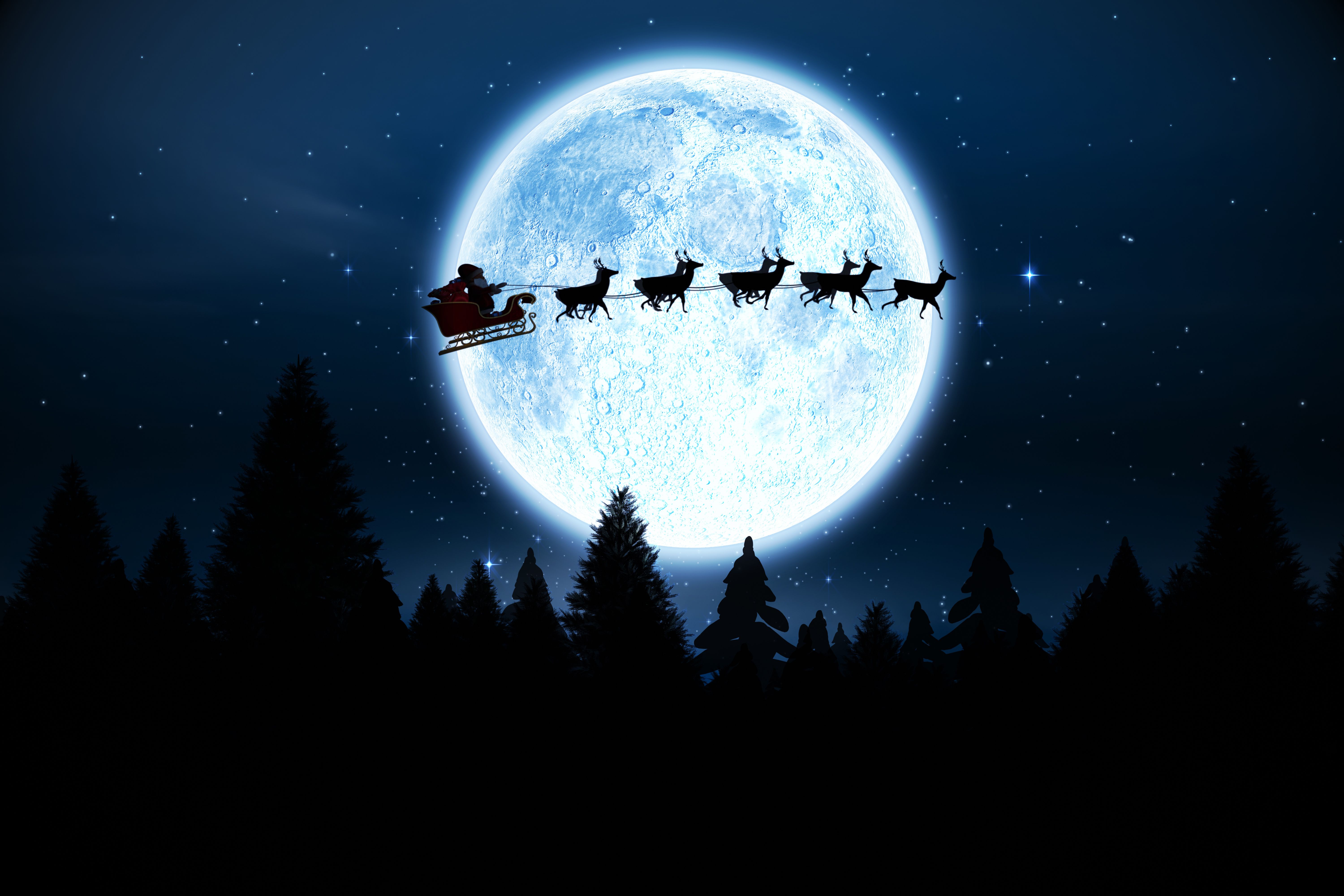 Santa Claus flying his sleigh and reindeer across a bright full moon on Christmas Eve