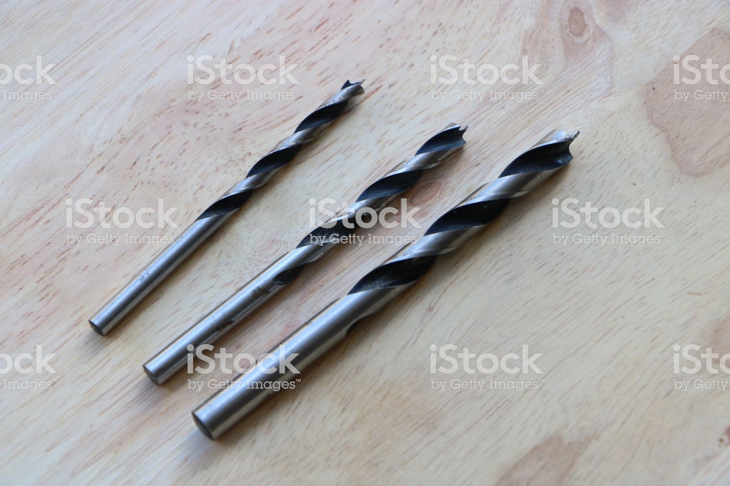 Set Of Twist Drill Bits On Wooden Background Stock Photo