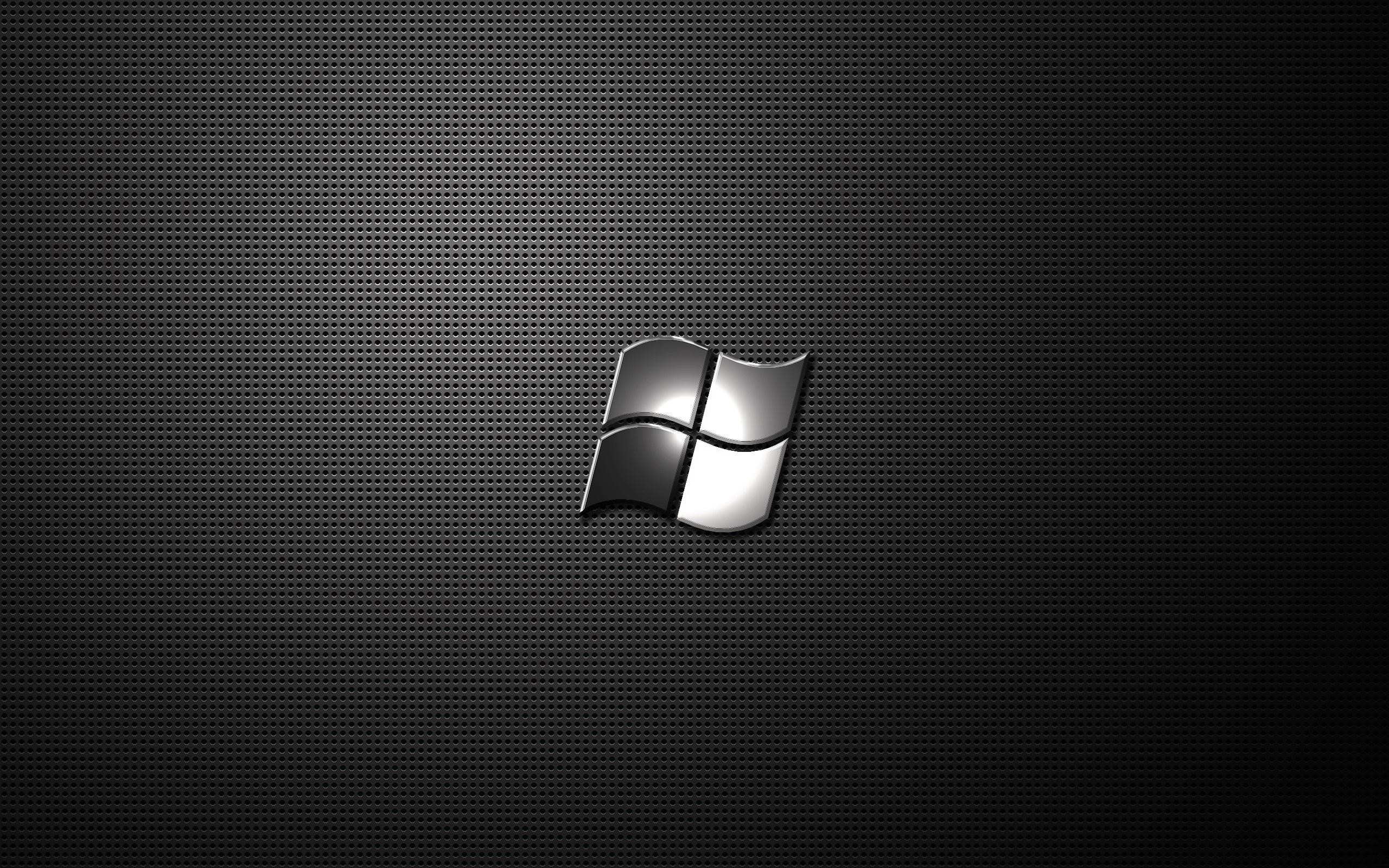 A sleek, dark metallic background with a subtle Windows logo, perfect for a minimalist Windows desktop