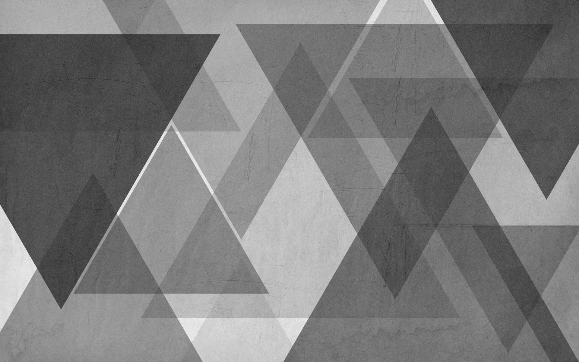 Abstract gray geometric background with overlapping triangles, creating a modern and stylish design